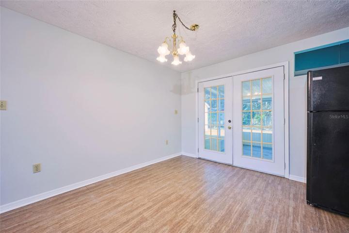 French doors lead to the large screened patio from the dining area