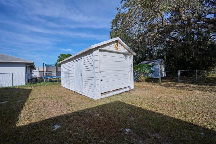 Large shed has side entrance and rolling door