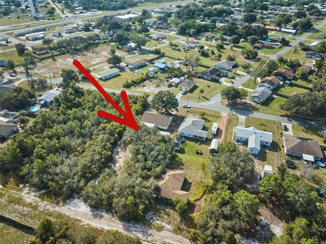 Property extends to the dirt road in the back of the wooded area