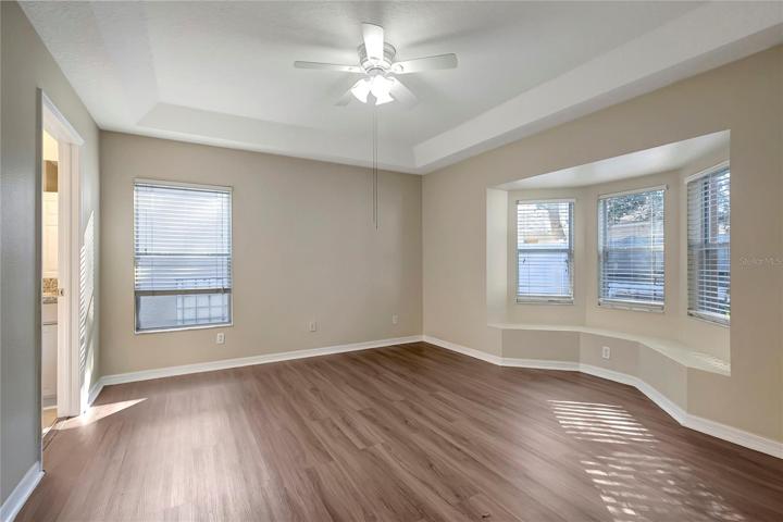 MASTER BEDROOM WITH BAY WINDOW AND WINDOW SEAT.