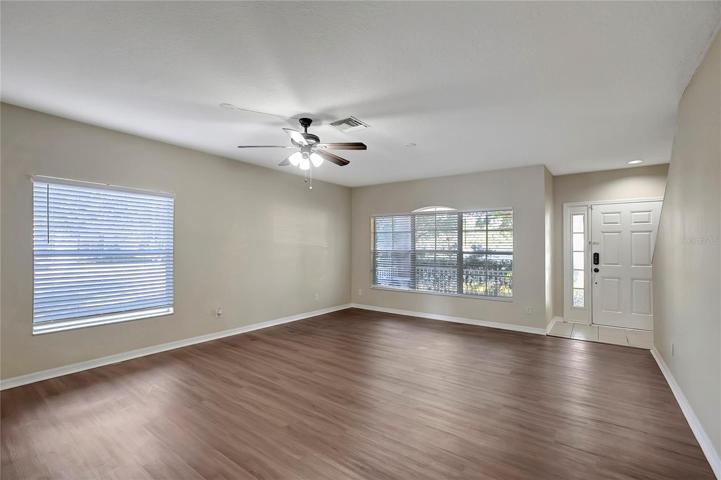 LIVING ROOM WITH LARGE WINDOW OVERLOOKING THE FRONT PORCH.