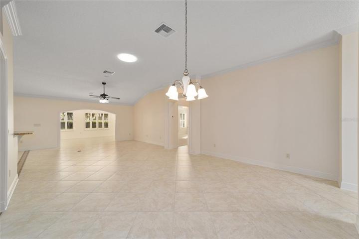 Dining room looking into living room with arch entry to Florida Room