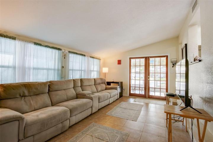 2nd view of family room with french doors leading out to front screened porch