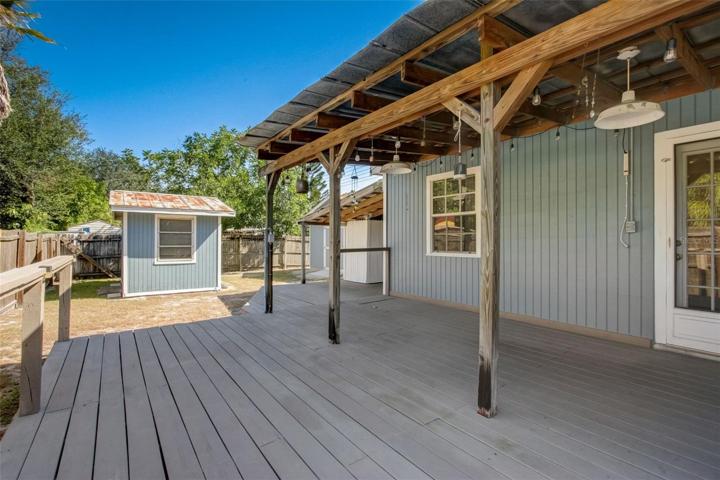 View of back porch with shed and 2 car garage