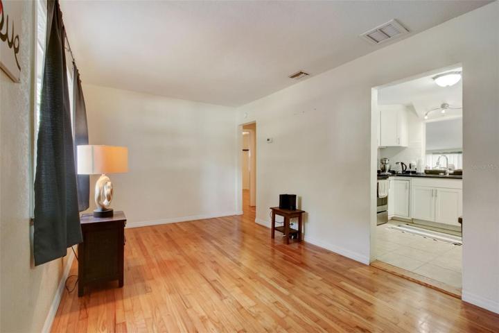 View of living room with doorways to the kitchen and bedrooms
