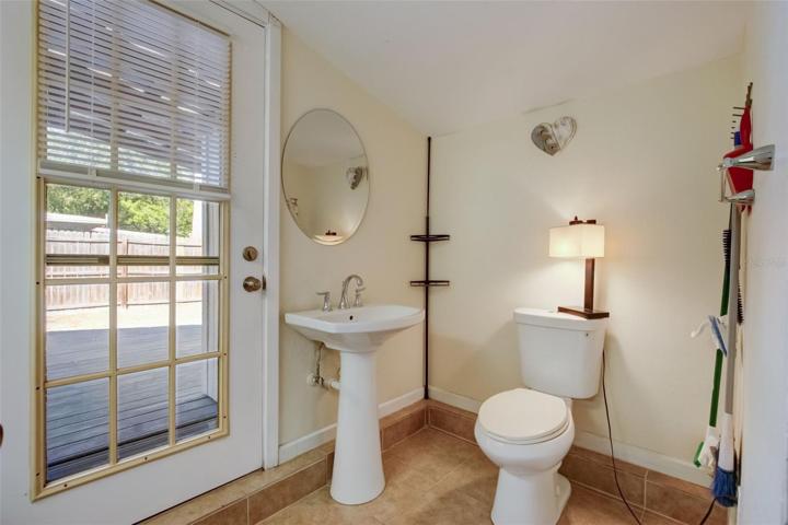 View of hall bathroom leading to back porch