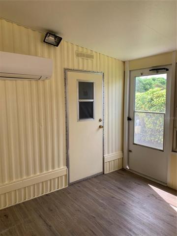 Room in Carport with door to storage/workshop  and door to side yard