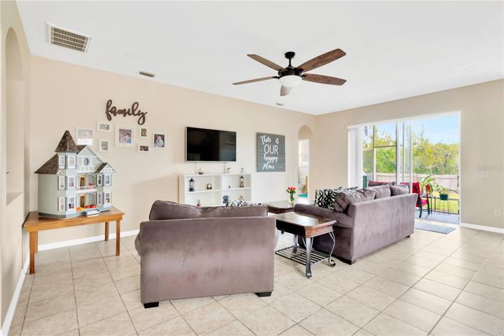 Family room adjacent to screened in patio and backyard