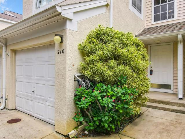 Garage entryway with mature landscape