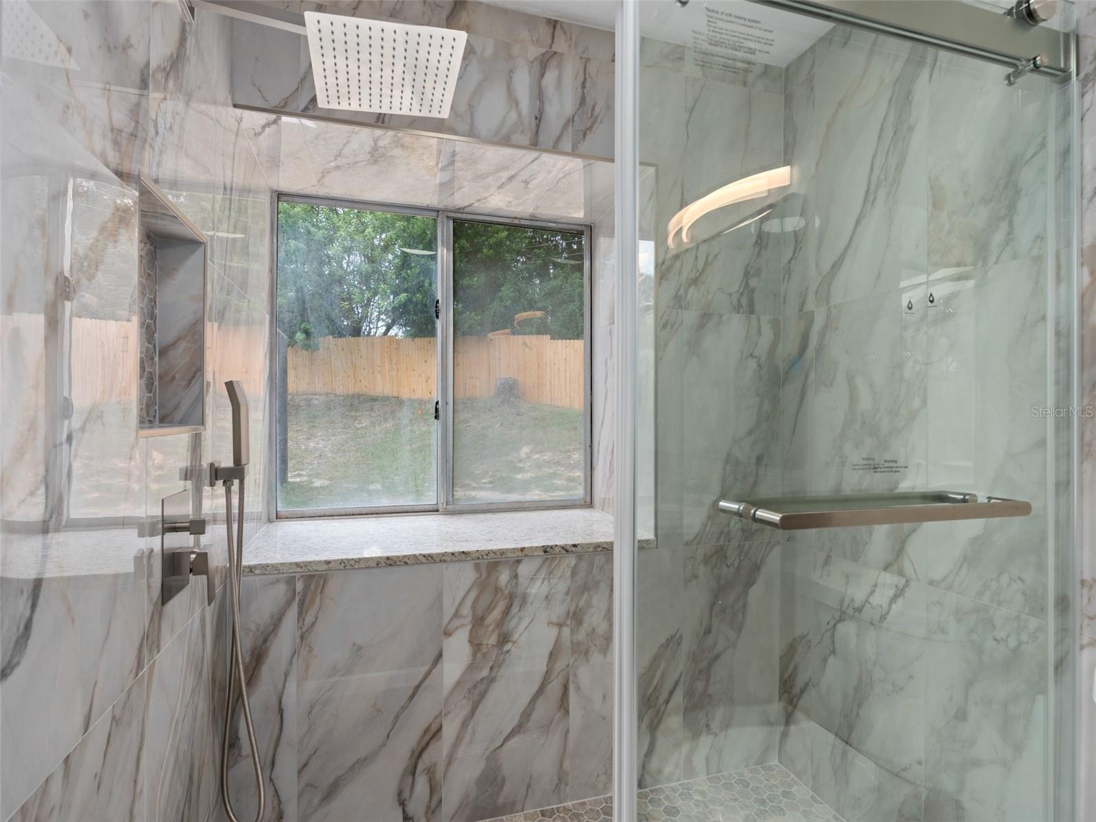 MASTER BATHROOM shower redone with a frameless glass door and beautiful tile and gorgeous upgraded fixtures