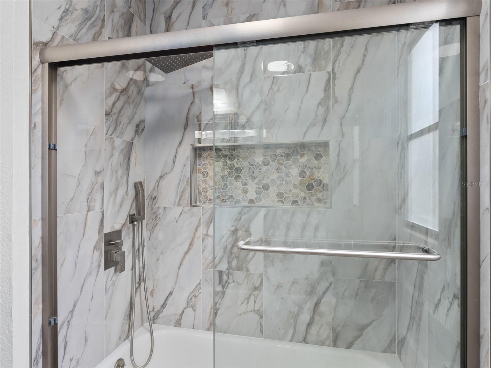 Bathroom 2 completely redone shower with frameless glass door, upgraded premium tile and beautiful fixtures.