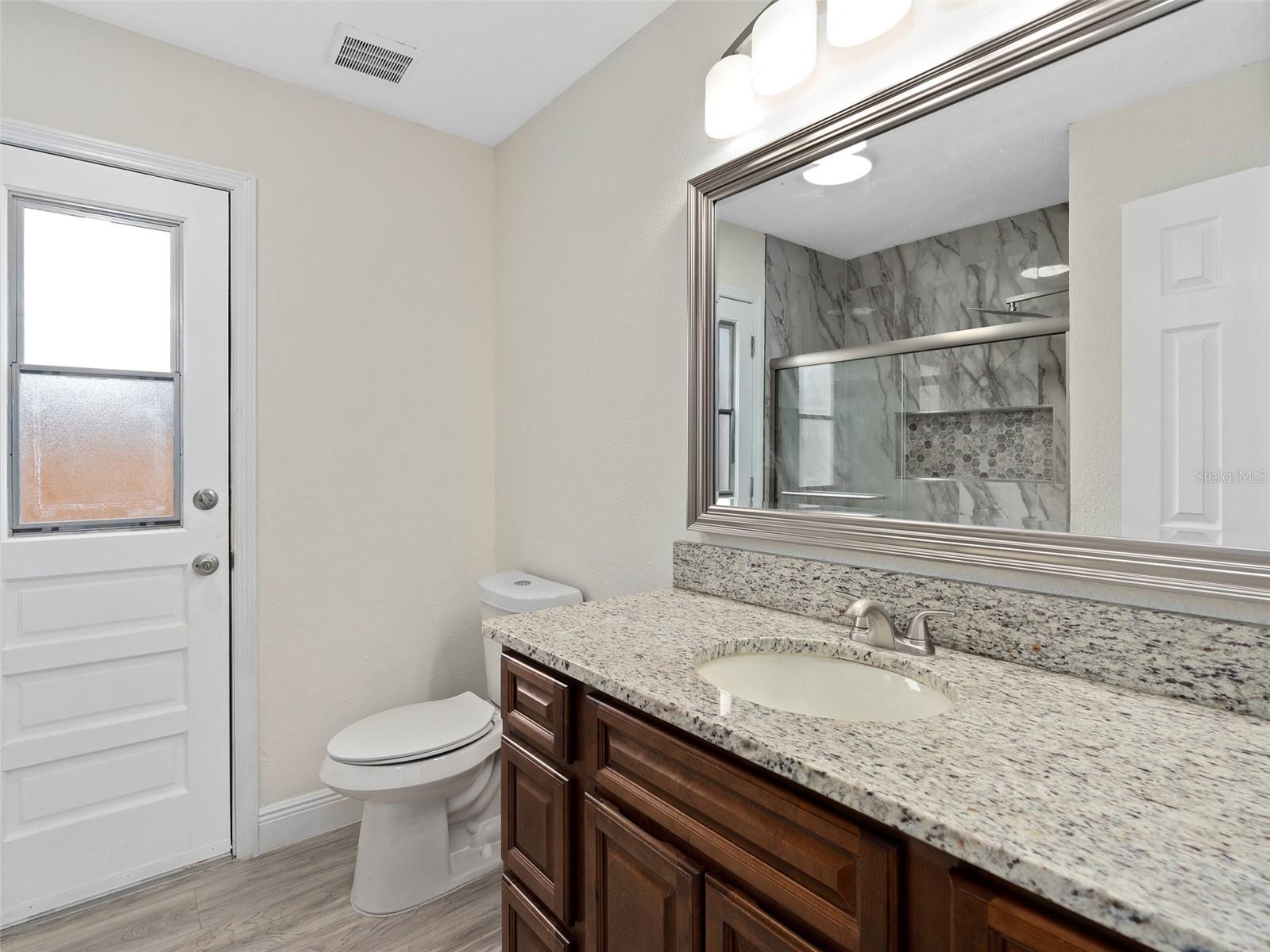 bathroom 2 with granite countertop and under mounted sink