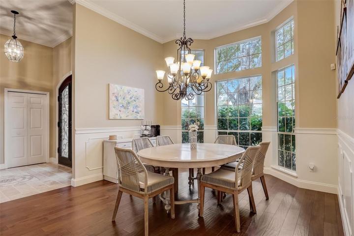 Formal dining room with large windows & wall molding
