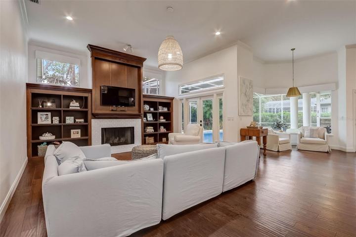 Spacious & bright family room with French Doors, custom built in with a fireplace!