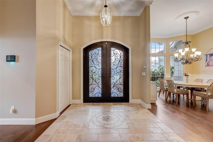 Grand foyer with travertine tile floors