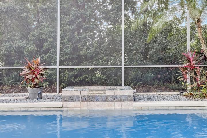Pool waterfall adding a touch of serenity