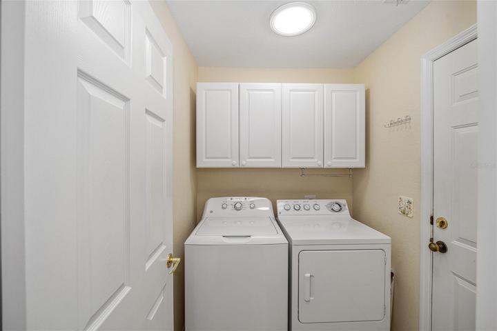 Inside Laundry with Cabinet Storage and Solar Tube