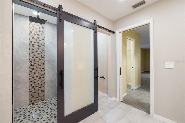 barn door covers either the water closet door or the shower