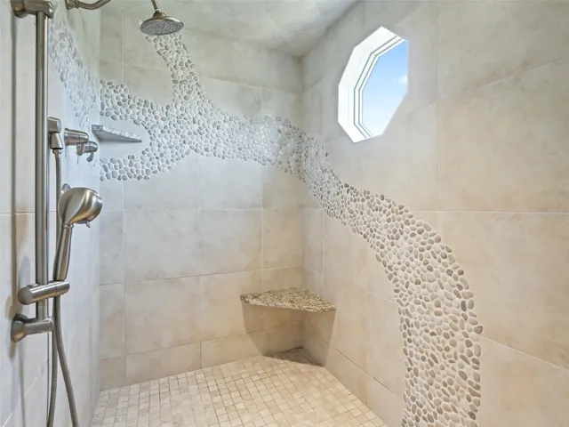 Inside large primary shower with multiple heads.