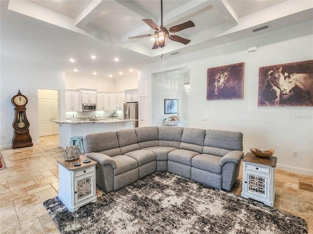 Fantastic Great room with Travertine flooring leading to the lanai.