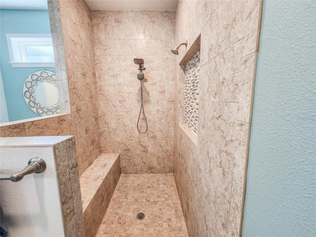 Full sized shower bench and multiple shower heads for a spa like experience