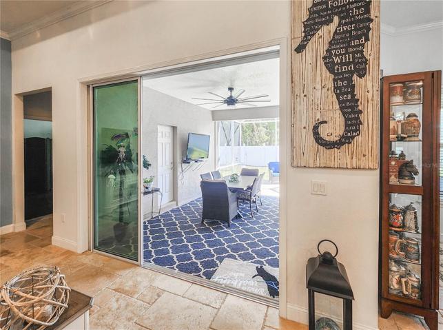 Triple sliding glass doors lead to the lanai from the main living area