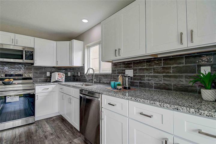 New white cabinets, new granite countertops, all new kitchen Samsung ss appliances.