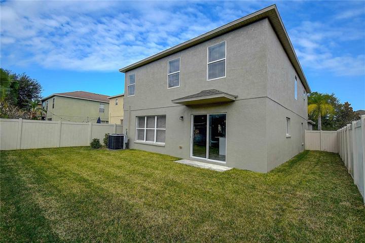 Exterior view fully fenced yard, with solid privacy vinyl fence.