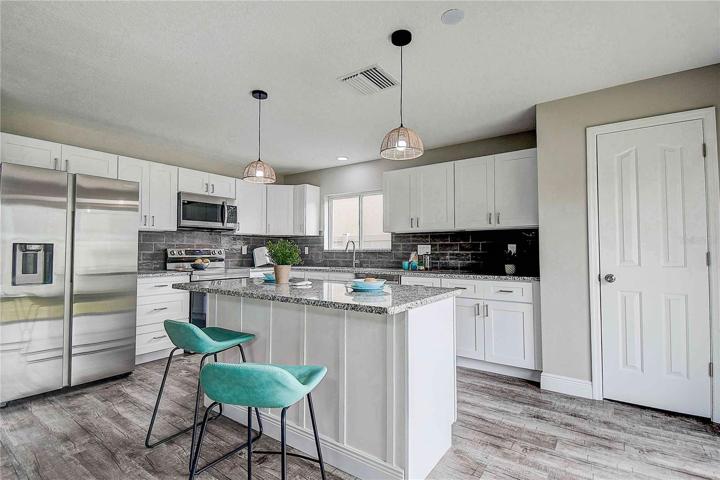 Streamlined kitchen with NEW pendant lighting, closet pantry.