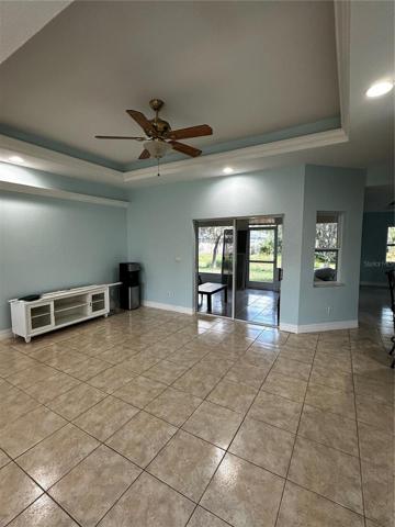 spacious living room with tray ceiling