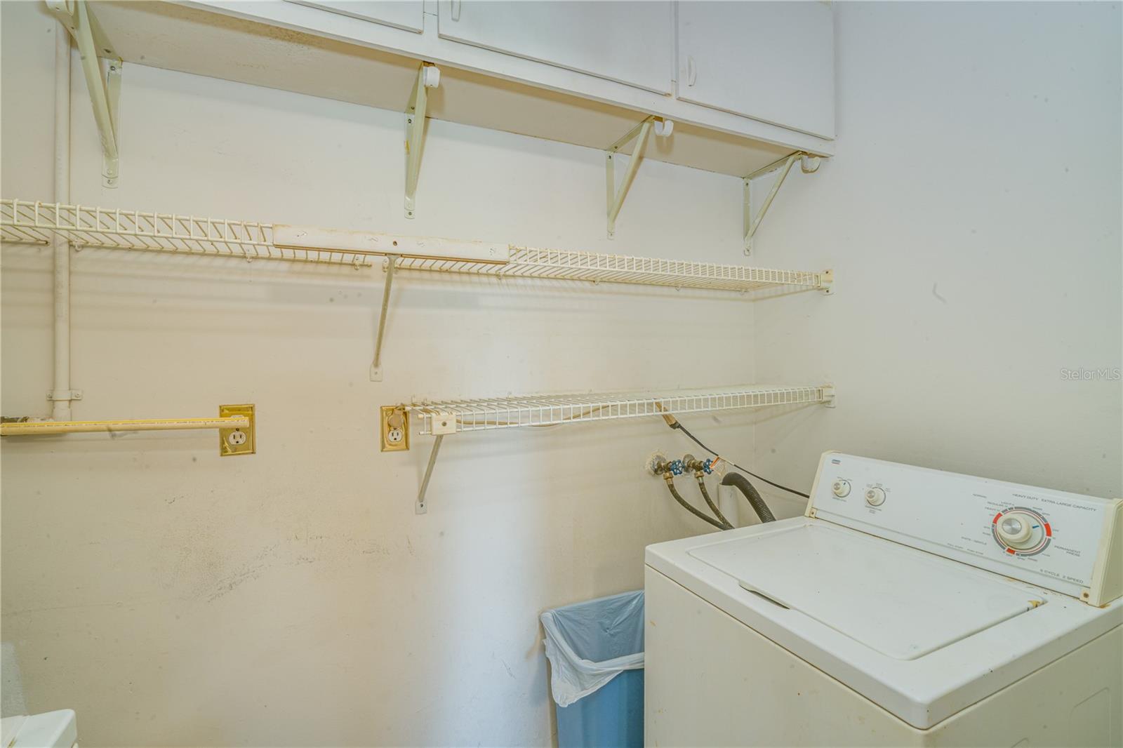 Inside washer + dryer off kitchen