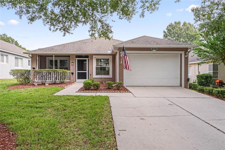 Front of Home showing garage, double car driveway, front walk and covered and screened front porch and entry