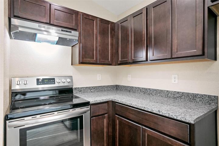 Granite countertops and lots of kitchen cabinets for storage