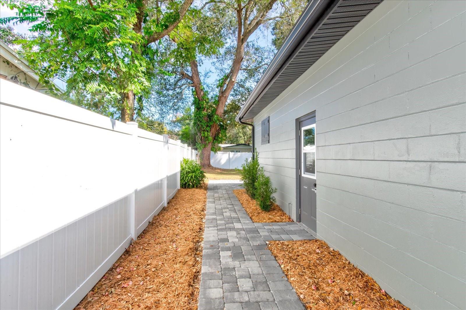 New paver walkway on side of house.