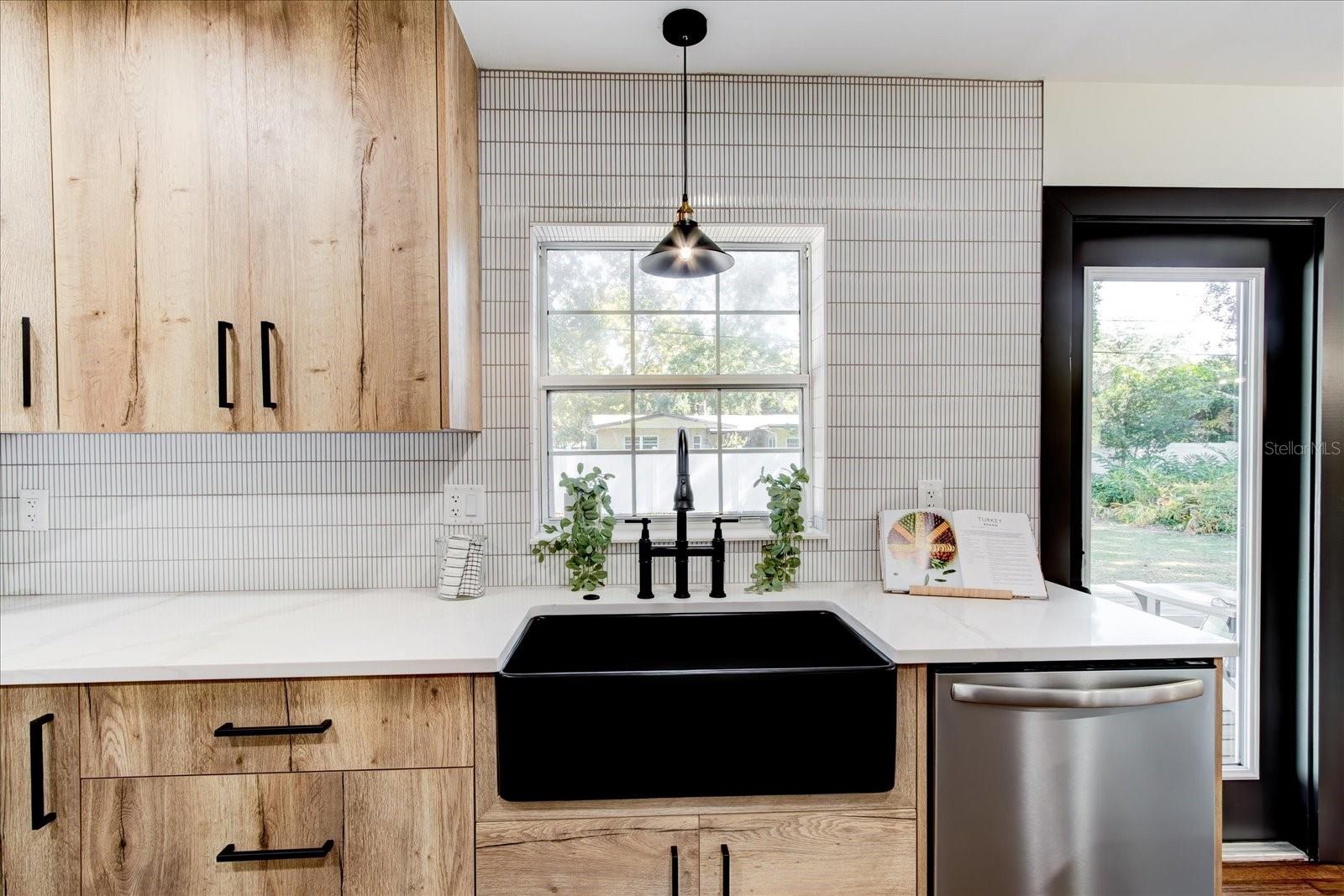 Kitchen sink has view of back yard and deck area.