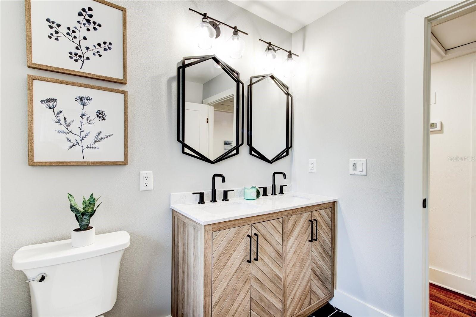 Double sink vanity with black accent features.