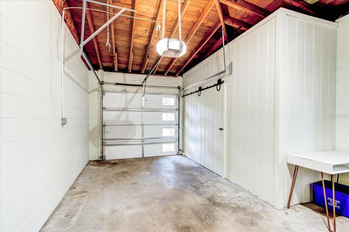 1 car garage with high ceilings and storage.