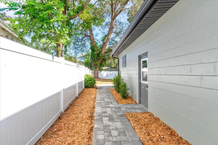 New paver walkway on side of house.