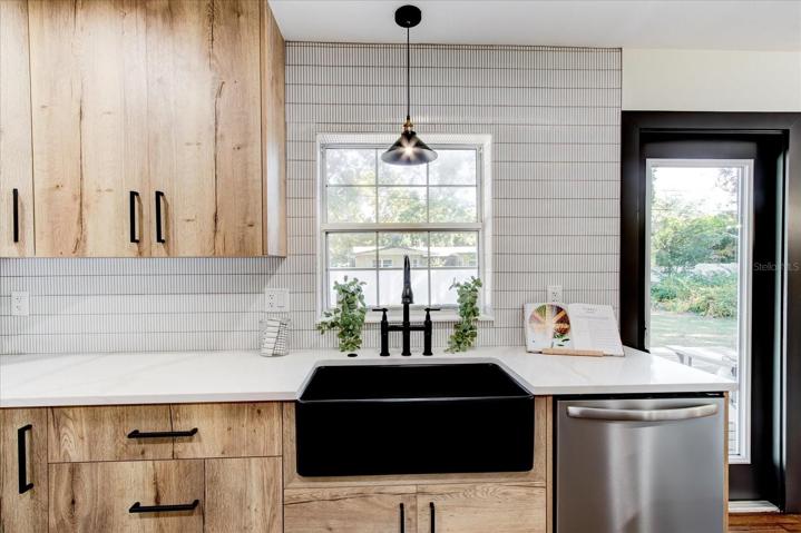 Kitchen sink has view of back yard and deck area.