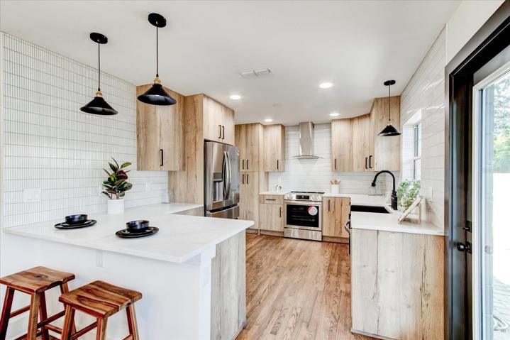 Chef's kitchen with stainless steel appliances and custom cabinetry.