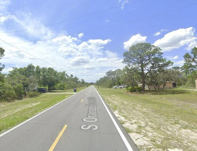 Street scene looking south along S Orange Blossom Blvd.