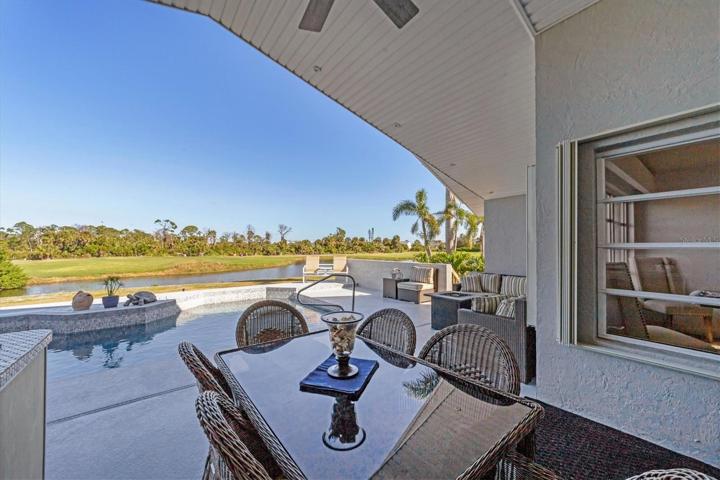 14x8 covered lanai with an outdoor kitchen, views of the pool, golf course and pond