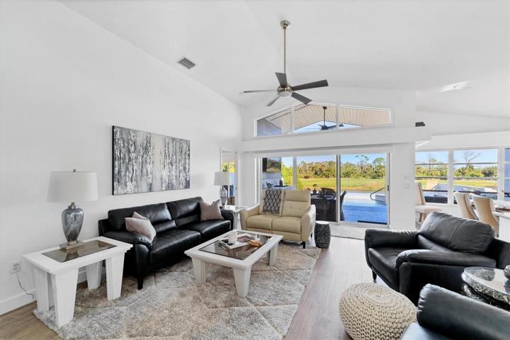 Bright and airy livingroom with wood floors and upgraded fan