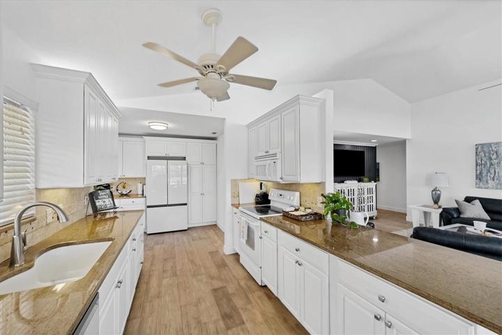 Upgraded kitchen cabinets with wood shelving anfd pull outs.  Granite countertops and stone backsplash