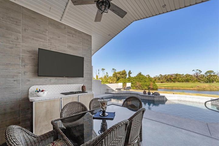 Outdoor kitchen with tiled wall, fridge and cooktop