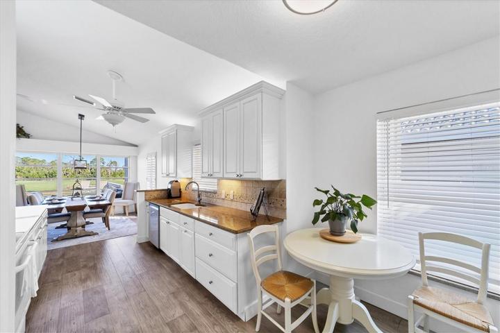 The kitchen has lots of cabinets, natural lighting and new Samsung Bespoke dishwasher and fridge.