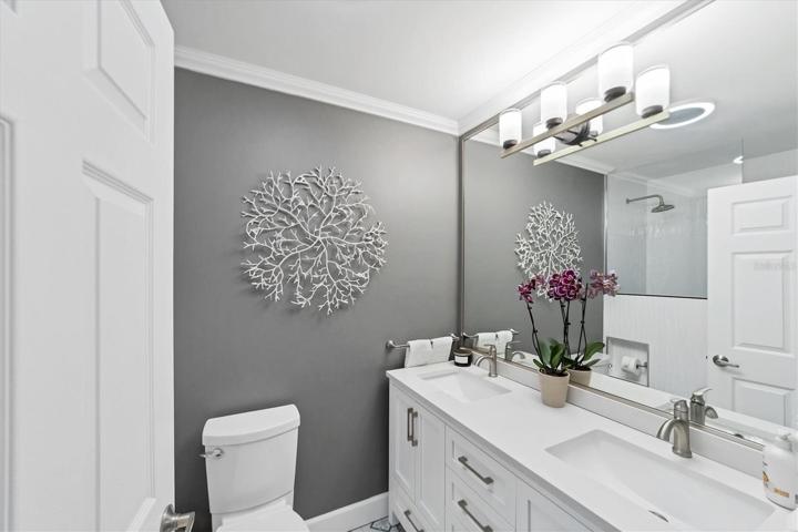 Completely upgraded guest bath with dual sinks and shower.