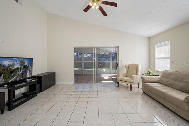 Large Family Room featuring vaulted ceiling and sliding doors to the large Florida Room, expanding your entertaining area even more!