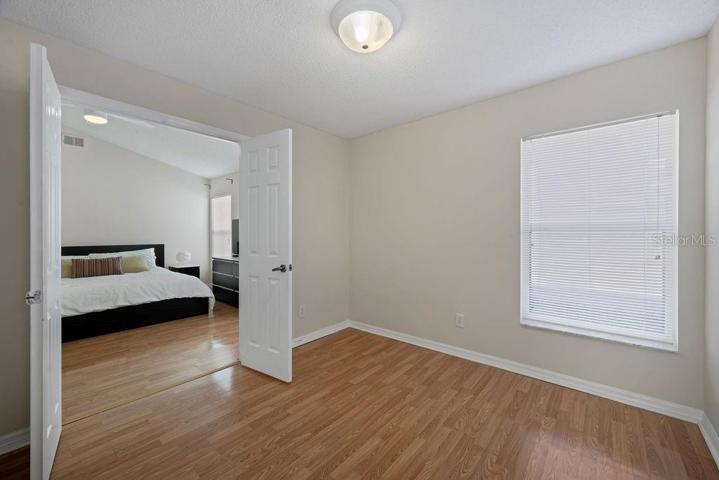 Owner's Suite from the adjoining multi-use room, which may be used as a sitting room, exercise room, study, or more. This room also has it's own closet and entrance from the guest hall, to be used as a fourth bedroom.