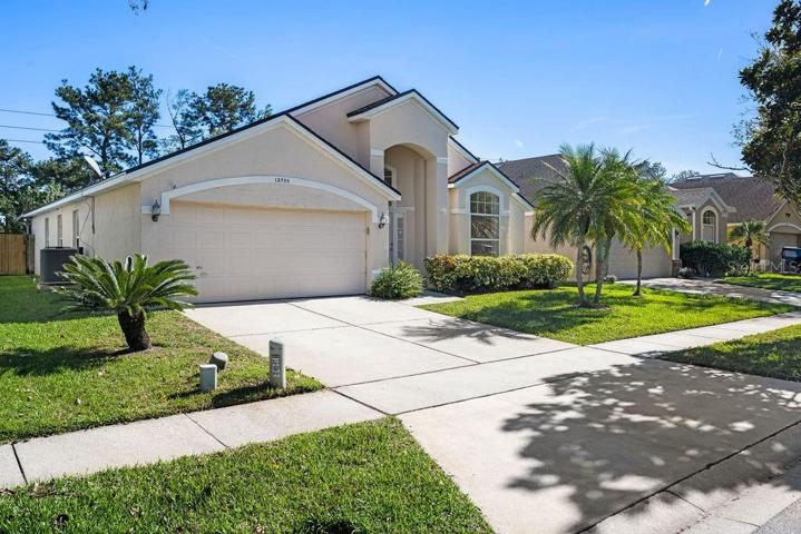 Front entrance to home with 2-car garage, driveway and additional curbside parking.